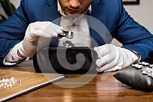 View of jewelry appraiser examining gemstone