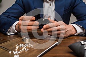 View of jewelry appraiser holding box