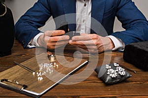 View of jewelry appraiser holding box