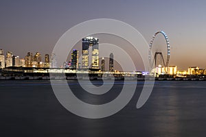 View of A Jumeirah Beach Residence and Blue waters after sunset . Shot made from Palm Jumeirah, man made island. Tallest ferris