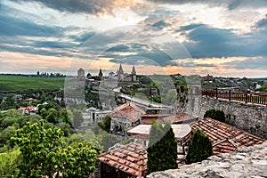 View of Kamianets-Podilskyi Castle and nearby buildings at sunset, Ukraine. Horizontal orientation.