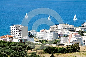 view of Karistos city and three sailboats in a row