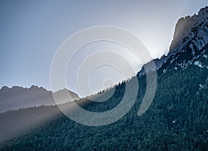 view on the karwendel mountains and first sun rays in the early morning in the alpine town of Mittenwald