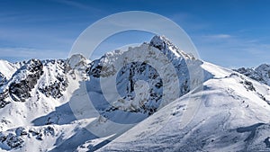 View from Kasprowy Wierch on adventurers climbing on Swinica mountain peak