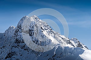 View from Kasprowy Wierch on adventurers who climbed on Swinica mountain peak at winter