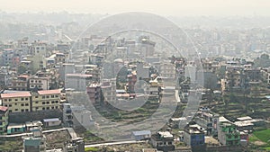 View of Kathmandu capital of Nepal from mountain through urban haze with lot of low rise buildings