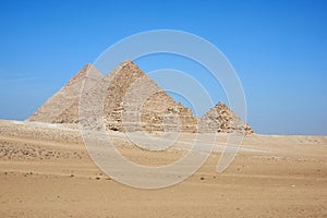 View on Khafre, Menkaure and pyramids of Queens from desert.