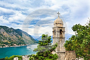 View of Kotor city, Church of Our Lady of Remedy, mediterranean sea and mountain landscape in Bay of Kotor, Montenegr