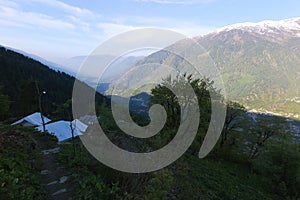 View of Kullu Valley and the mountains overlooking Manali town from camp site at Hamta, Himachal Pradesh, India