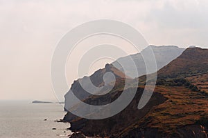 View of La Lastra cliffs near Laredo shrouded in mist in the early morning. photo