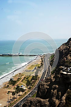 view of La Rosa Nautica by the sea in Makaha Beach.Route costa verde, Group of surfers learning to surf in a bright summer