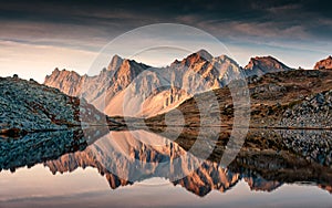 View of Lac Long with massif Des Cerces reflection on the lake in Claree valley at France