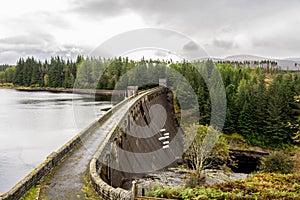 A view of Laggan Dam with 6 pipes to release water from the loch to river Spean, Scotland