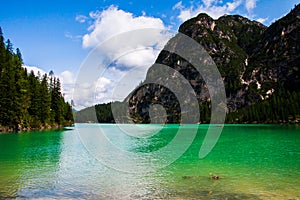 View of Lago di Braies between the dolomiti mountains, a cloudy summer day