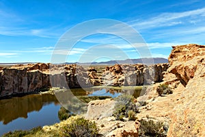 View of the Laguna Negra, Black lagoon Lake wedged between rock formations in Altiplano, Bolivia