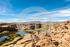 View of the Laguna Negra, Black lagoon Lake wedged between rock formations in Altiplano, Bolivia