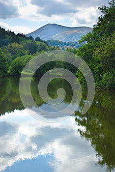 View of Lake Aydat in Auvergne, summer and cloud reflections