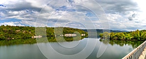 View at the lake with calm water, trees reflection, and beautiful sky