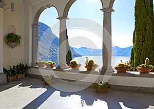 View of Lake Como and mountains through the arches, Varenna, Province of Lecco, Lombardy, Italy