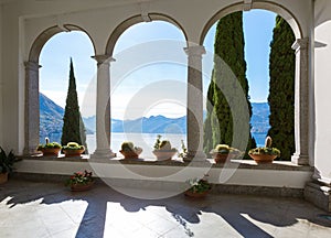 View of Lake Como and mountains through the arches, Varenna, Province of Lecco, Lombardy, Italy