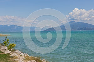 View of Lake Garda in Italy. Daytime. Calmness. Nobody. Nature. Panoramic view. Blue clear water. Landscape.