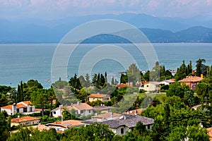 View of Lake Garda, summer landscape. Blue lake, mountayns Alps. Castelnuovo del Garda, Italy - August, 13 2019