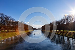 View on a lake with reflections of trees in the water, rowing boat on the lake