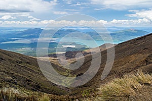 View of lake Rotoaira and lake Taupo from Tongariro Alpine Crossing hike with clouds above