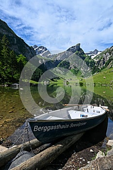 View on lake Seealpsee with a little boat in the Swiss alps