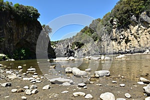 view of the lake shore with stones and sand photo