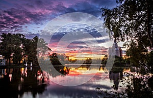 View of lake, sky, hangover trees and church on repair at sunset