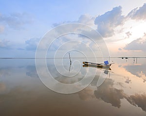 A view of a lake with a sunset background