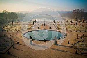 View of the lake in the Versailles garden in the morning mist