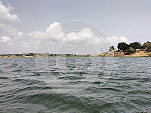 View of lake with wave. The beautiful clear lake with cloudy sky
