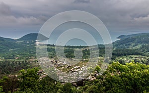 view of land from top of hill with large lake in distance