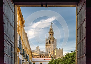 View of landmark Giralda tower as seen from Seville Cathedral patio doors.