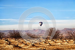 View of the landscape in the Cappadocia valley with mountains in the distance on the horizon and blue sky