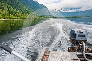 View of the landscape of the coast, the coastal strip of the lake with a boat leaving