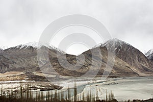 View landscape mountains range with nubra and shyok river when evaporated dry between Diskit Turtok highway road go to Pangong