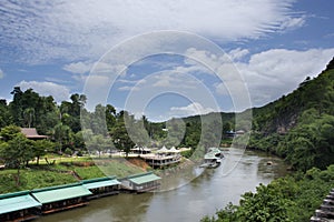 View landscape and raft house float on si sawat or khwae kwai river with hellfire pass mountain forest in Sai Yok Waterfall