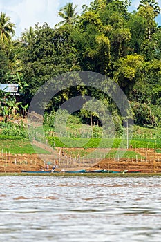 View of the landscape of the river Nam Khan, Luang Prabang, Laos. Copy space for text. Vertical.