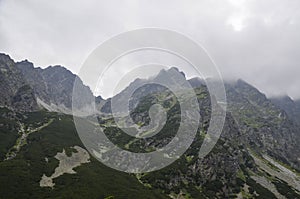 View of landscape and rocky foggy mountains against cloudy sky in High Tatras, Slovakia