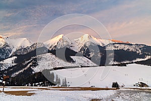 View of the landscape with snowy mountains and ski slopes