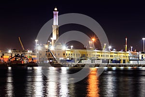 View of Lanterna (lighthouse) in the old port of the city of Genoa at night, Italy photo