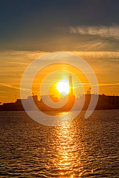 View of Lanterna (lighthouse) in old port of the city of Genoa at sunset, Italy