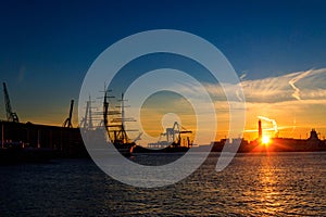 View of Lanterna (lighthouse) in old port of the city of Genoa at sunset, Italy