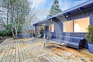 View of large back deck with outdoor furniture