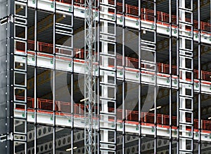 View of a large building development under construction with steel framework and girders supporting the metal floors