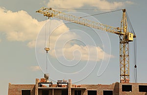 View of a large construction site with buildings under construction and multi-storey residential homes. Tower cranes in