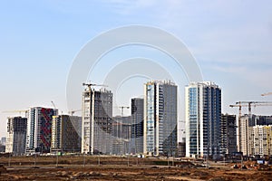 View of a large construction site. Tower cranes in action. Housing renovation concept. Crane during formworks. Construction the